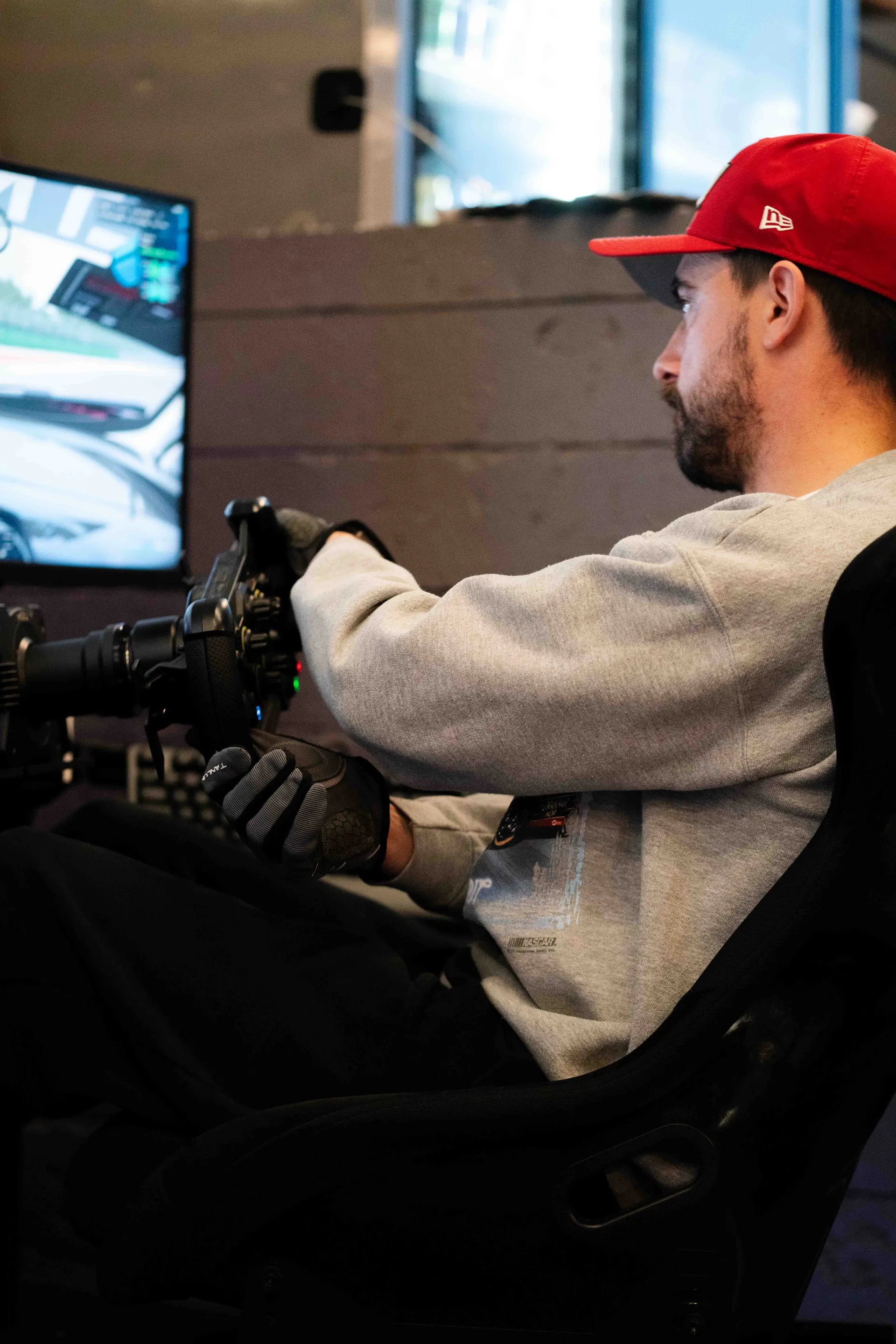 Driver gripping the wheel in full concentration at Grid Lounge Cedar Falls